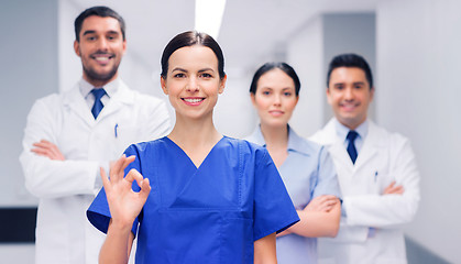 Image showing group of medics at hospital showing ok hand sign