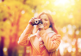 Image showing woman photographing with camera in autumn park