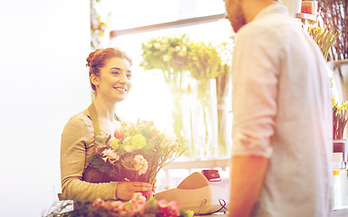 Image showing smiling florist woman and man at flower shop