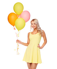 Image showing happy woman in dress with helium air balloons