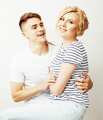 Image showing young pretty teenage couple, hipster guy with his girlfriend happy smiling and hugging isolated on white background, lifestyle people concept