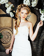 Image showing beauty young blond woman bride alone in luxury vintage interior with a lot of flowers 