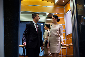 Image showing business team with travel bags in hotel elevator