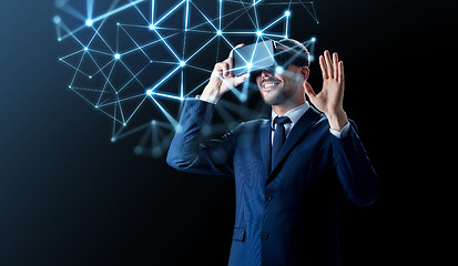 Image showing businessman in virtual reality headset over black