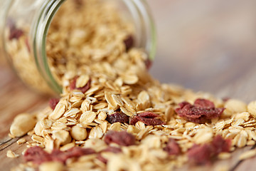 Image showing close up of jar with granola or muesli on table