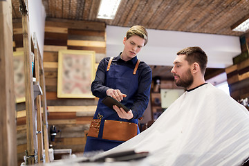 Image showing barber showing tablet pc to man at barbershop