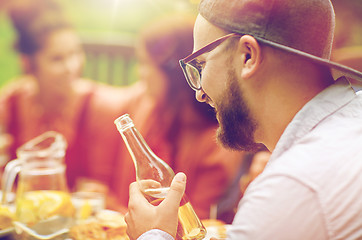 Image showing happy man with beer friends at summer garden party