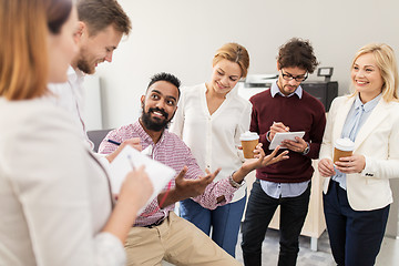 Image showing happy business team drinking coffee at office