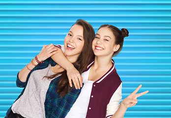 Image showing happy teenage girls hugging and showing peace sign