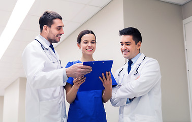 Image showing group of happy medics with clipboard at hospital