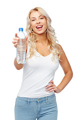 Image showing happy beautiful young woman with bottle of water