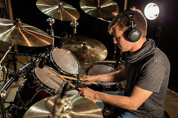 Image showing male musician playing drums and cymbals at concert