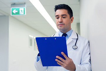 Image showing doctor writing to clipboard at hospital