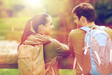 Image showing smiling couple with backpacks in nature