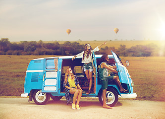 Image showing happy hippie friends in minivan car in africa