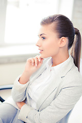 Image showing pensive woman in office