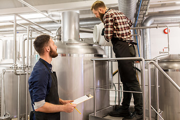 Image showing men working at craft brewery or beer plant