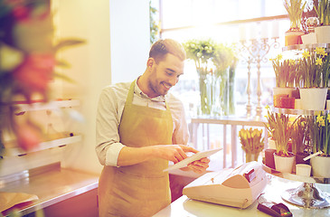 Image showing man with tablet pc computer at flower shop