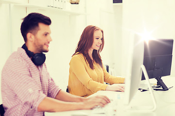 Image showing creative team with headphones and computer