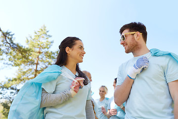 Image showing volunteers with garbage bags talking outdoors