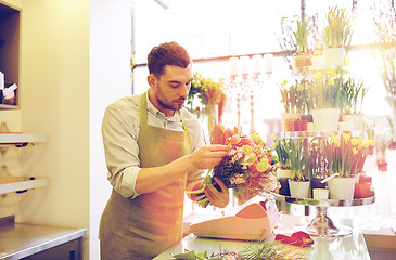 Image showing florist man making bunch at flower shop