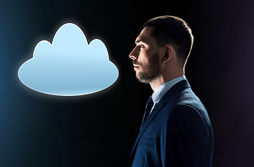 Image showing businessman in suit looking at cloud projection