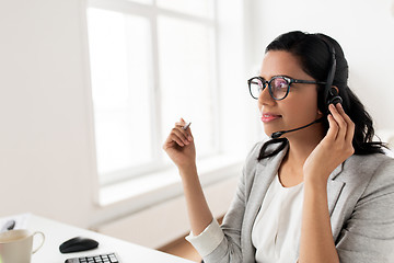 Image showing businesswoman with headset talking at office