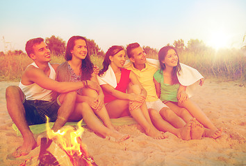 Image showing smiling friends in sunglasses on summer beach