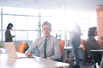 Image showing businessman working using a laptop in startup office