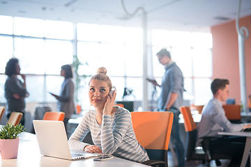 Image showing businesswoman using a laptop in startup office