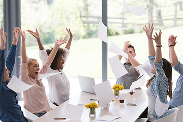 Image showing multiethnic startup Group of young business people throwing docu