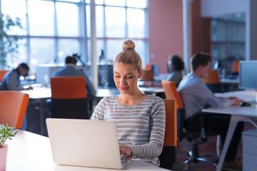 Image showing businesswoman using a laptop in startup office