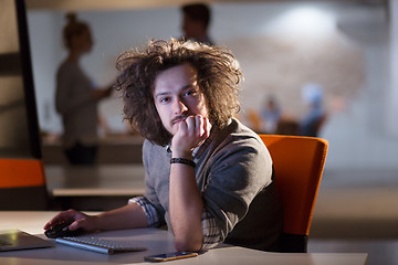 Image showing man working on computer in dark office