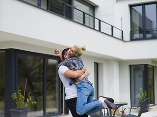 Image showing couple hugging in front of  new luxury home