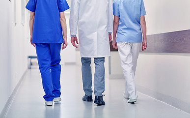 Image showing group of medics or doctors walking along hospital