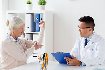 Image showing senior woman and doctor meeting at hospital