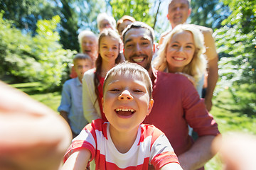 Image showing happy family taking selfie in summer garden