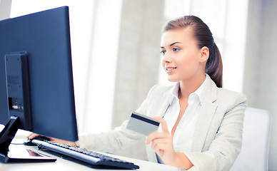 Image showing businesswoman with laptop using credit card