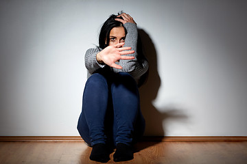 Image showing unhappy woman crying on floor at home