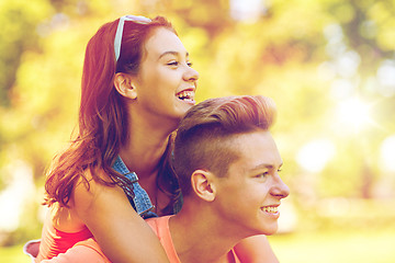 Image showing happy teenage couple having fun at summer park