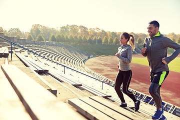 Image showing happy couple running upstairs on stadium