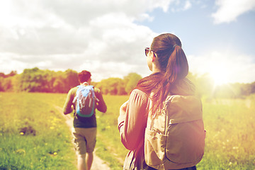 Image showing happy couple with backpacks hiking outdoors