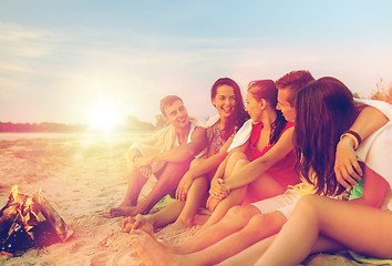 Image showing smiling friends in sunglasses on summer beach