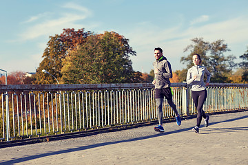 Image showing happy couple running outdoors