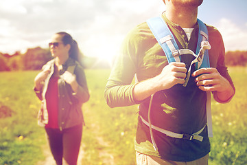 Image showing close up of couple with backpacks hiking outdoors