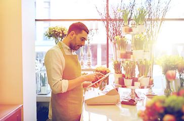 Image showing man with tablet pc computer at flower shop