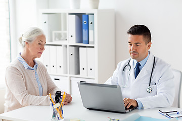 Image showing senior woman and doctor with laptop at hospital