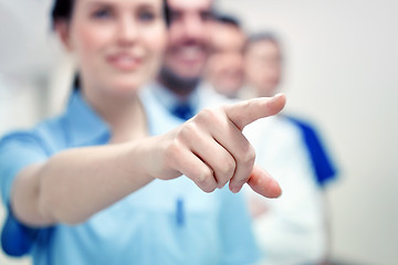 Image showing close up of doctor pointing finger at hospital