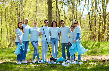 Image showing group of volunteers with garbage bags in park