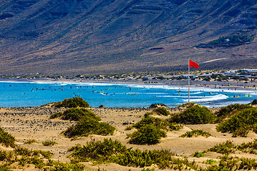 Image showing Surfers beach Famara on Lanzarote always has a red flag.